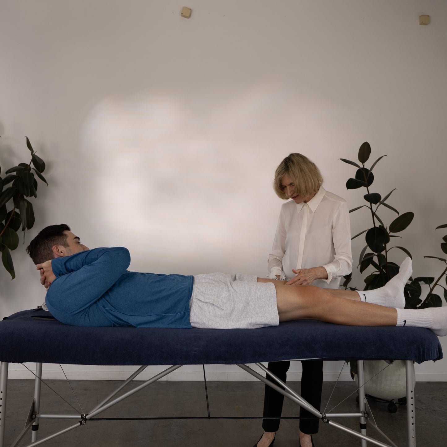 Physiotherapist Jenny McConnell applying McConnell Therapeutics tape in clinic setting using her taping technique