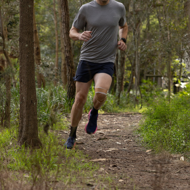 Athlete using McConnell taping for knee stability and patella support