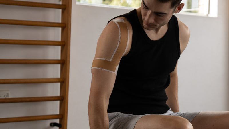 McConnell shoulder taping applied to the upper arm and shoulder for impingement and rotator cuff support