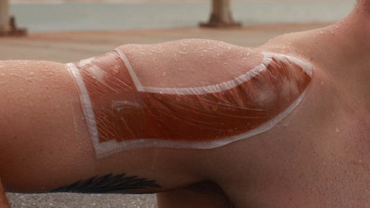 McConnell Therapeutics Tape Shield waterproof layer applied over shoulder taping to extend wear time during water exposure and activity