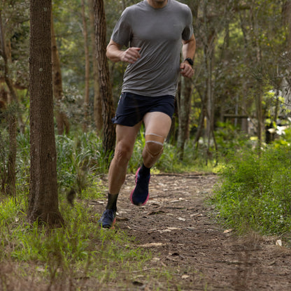 Athlete using McConnell taping for knee stability and patella support