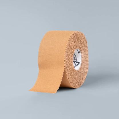 Close-up of McConnell Rigid Tape roll showing high-strength rayon fabric and zinc oxide adhesive texture